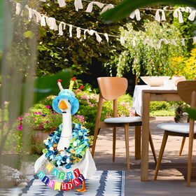Abbylike Blue birthday costume on goose statue brightens garden celebrations.