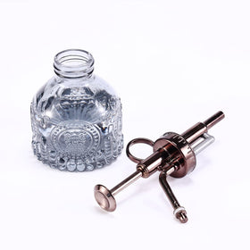 Aebor glass plant mister close-up reveals sturdy bronze pump and clear bottle