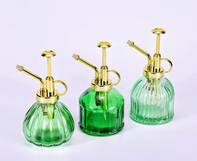 Aebor green glass bottle with gold top complements modern decor.