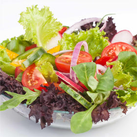 Green and red romaine leaves sprouting in an AeroGarden setup for fresh salads.