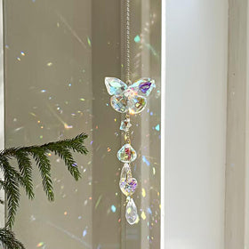 Afiaiwei butterfly crystal sun catcher hangs in a window casting colorful rainbows