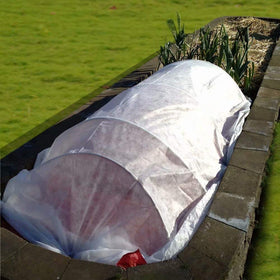 Agfabric cover protecting tomatoes and peppers while maintaining air flow for health.