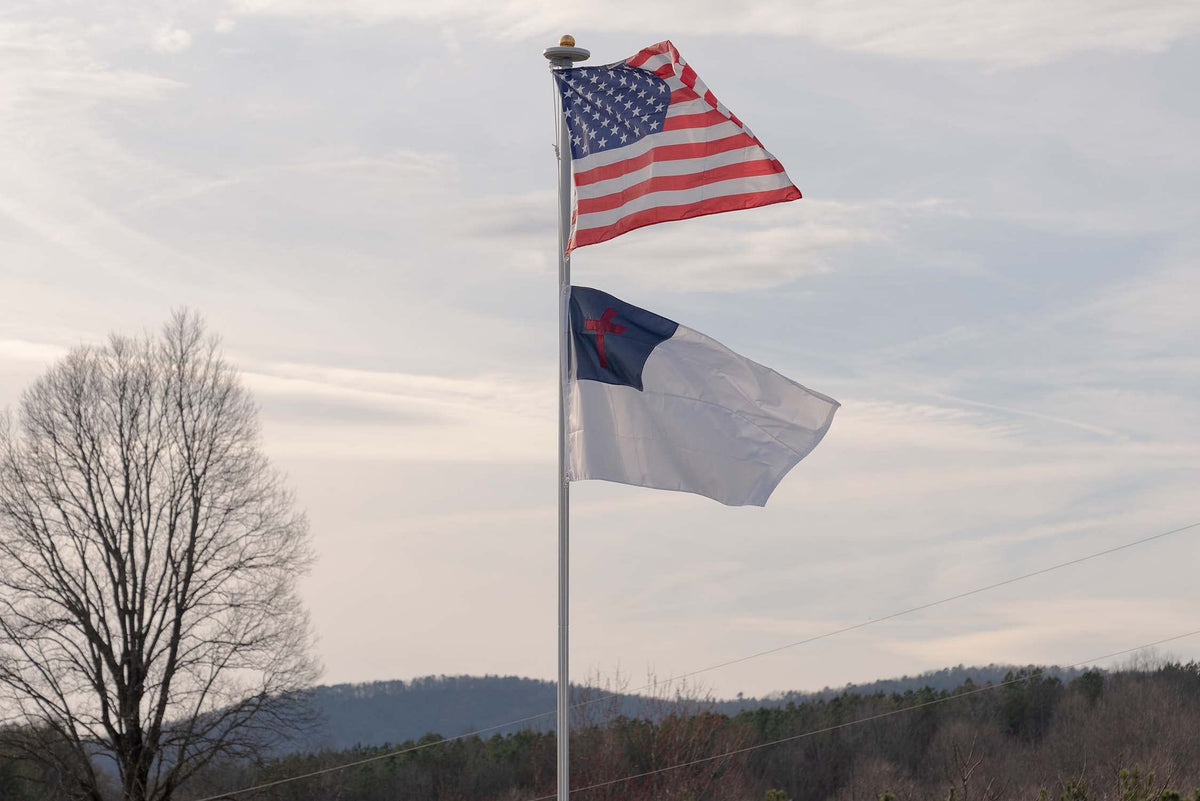 AGUIFLGS flag shown outdoors for ceremonies and faith gatherings.