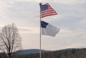 AGUIFLGS flag shown outdoors for ceremonies and faith gatherings.