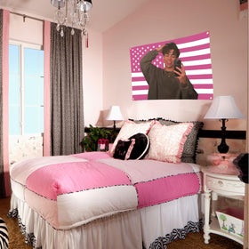 Aieted pink Malachi Barton flag displayed in garden or patio.