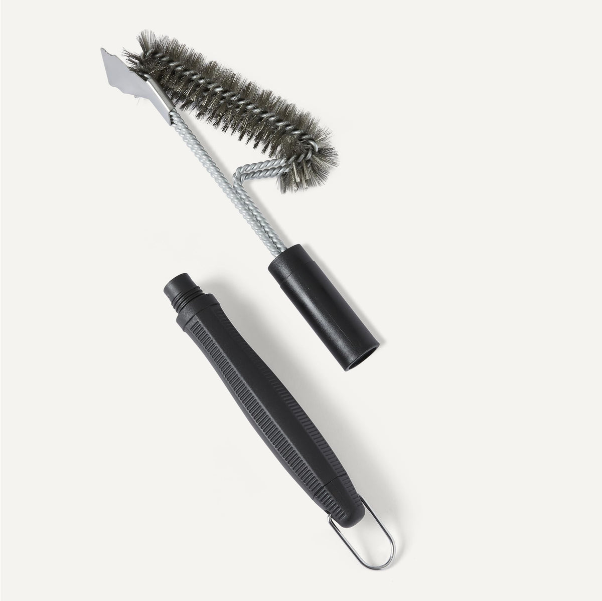 Amazon Basics grill brush with steam-clean capability demonstrated on hot grates.