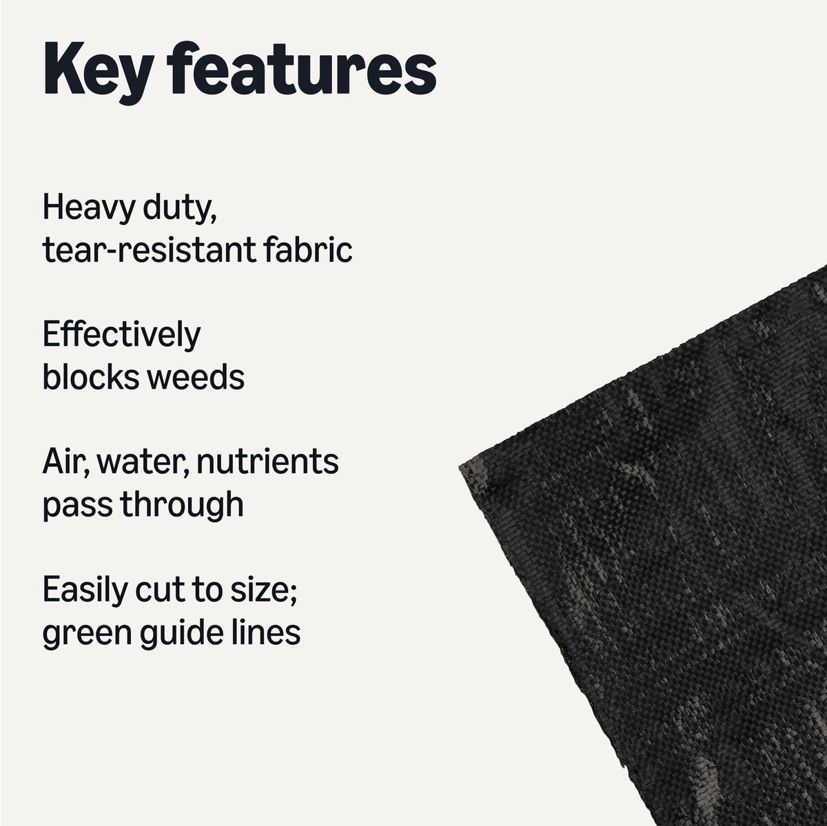 Amazon Basics landscape fabric laid out in a garden bed with green guide lines for easy alignment.