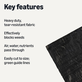 Amazon Basics landscape fabric laid out in a garden bed with green guide lines for easy alignment.