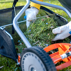 GC91416 catching grass and leaves during mowing for efficient collection.