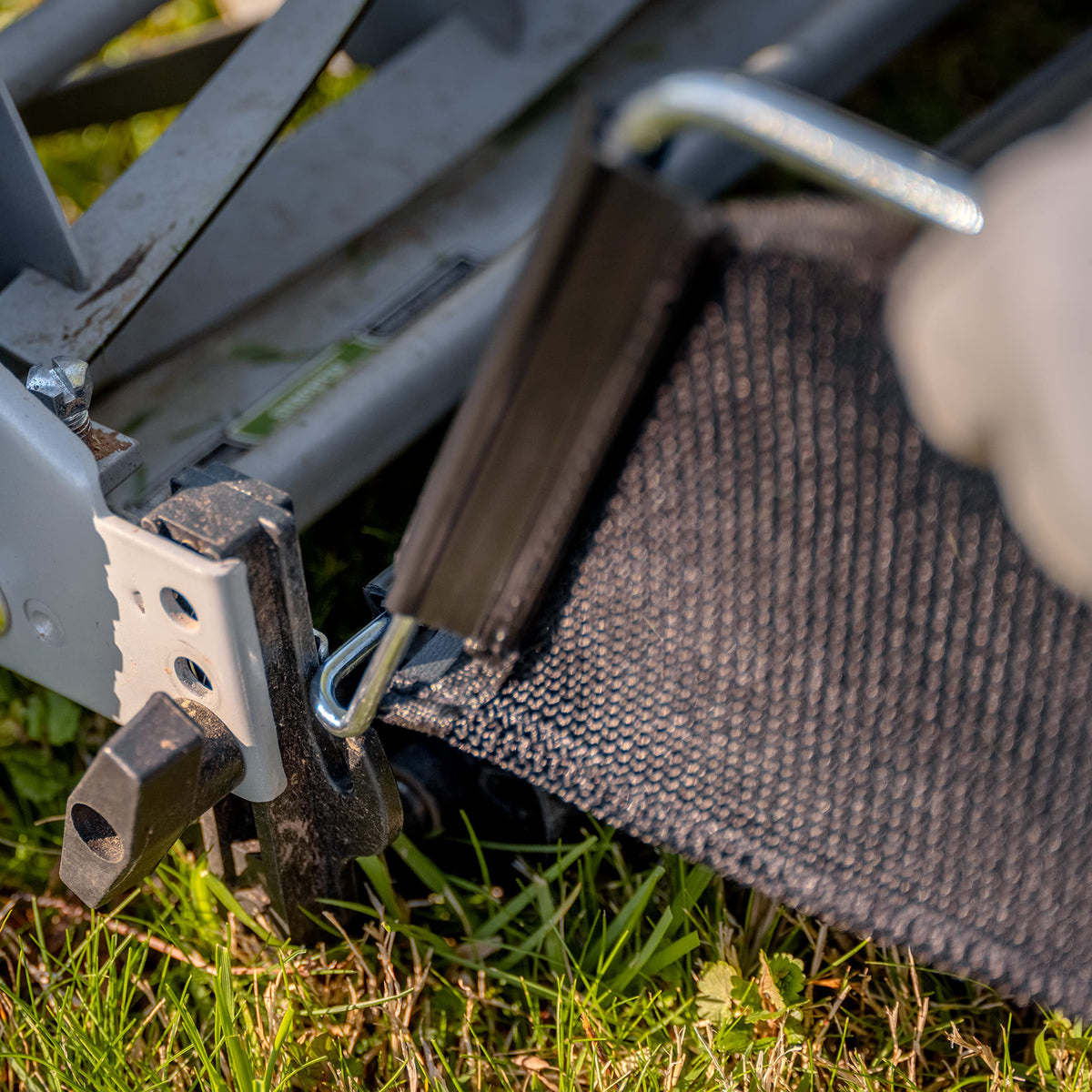 GC91820 grass catcher in use capturing clippings on a sunlit lawn