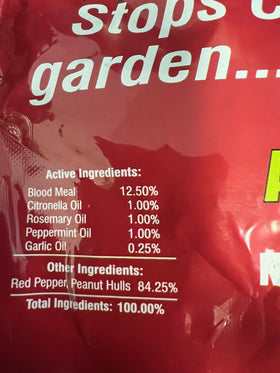 Garden bed protected by America'S Finest Scram for Cats around plants.