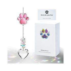 AMETHUARTZ Pet Memorial paw crystal pendant catches sunlight to cast rainbow colors.