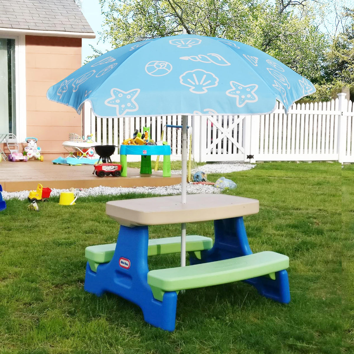 Kids enjoy shaded picnic at a small table under AMMSUN umbrella.