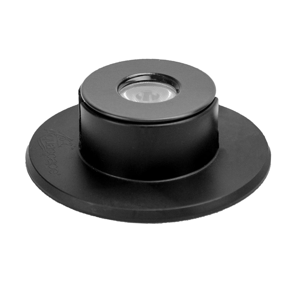 Aquascape 1-Watt submersible waterfall light highlights pond edges at night.