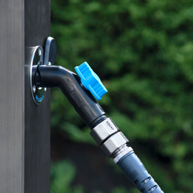 Aquor hose connector demonstrates quick connect under water pressure for outdoor setups.