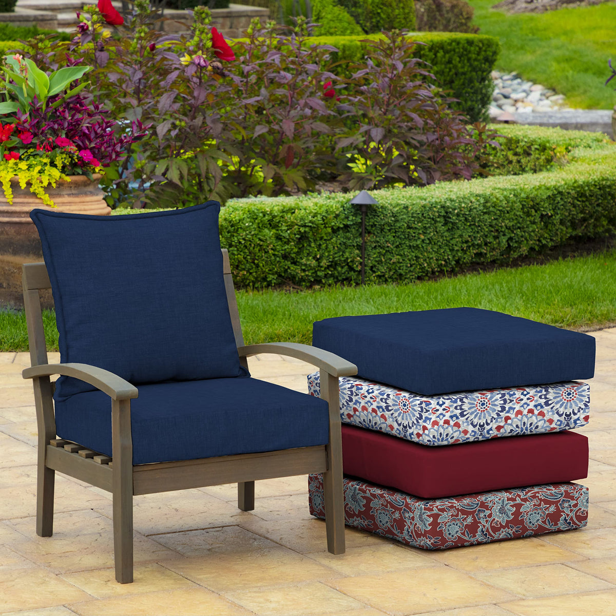 Arden Selections Sapphire Blue cushion shown on an outdoor chair setup