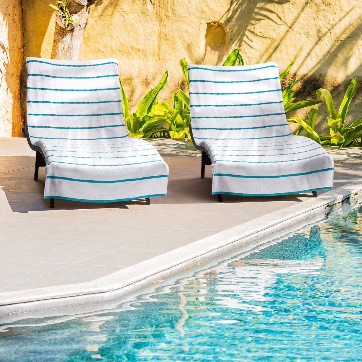 Arkwright Las Rayas striped chaise cover on an outdoor chair by the pool.