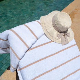 Stripes on Arkwright Las Rayas chair cover adding vibrant poolside style