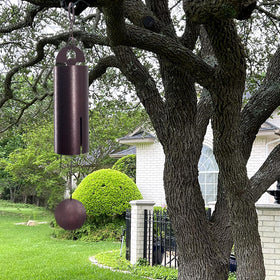 ASTARIN wind chimes outdoors in deep tone creating tranquil backyard ambience.