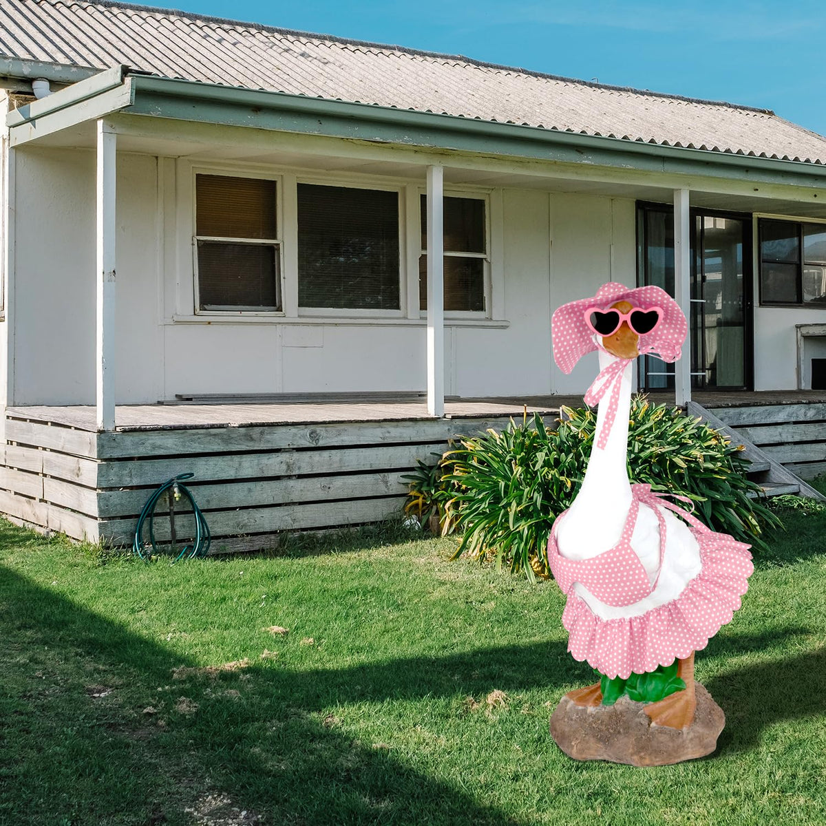 Aymolas pink heart sunglasses add whimsy to garden geese display.