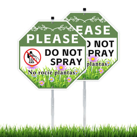 AzReference do-not-spray sign two-pack with stake installed in a sunny yard for outdoors