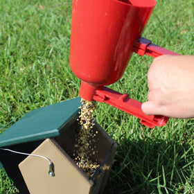 Backyard Essentials bird seed scoop in action with quick release.