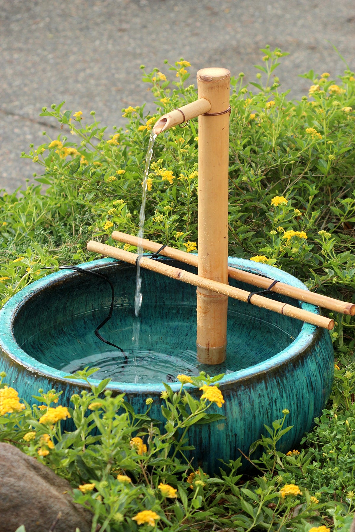 Bamboo Accents branch-arm spout showcases natural design for calming water flow.
