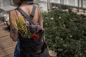 Barebones harvesting bag side view demonstrates portable design with adjustable strap.