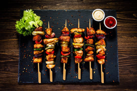BBQStyle flat-handle paddle skewers reduce slipping while turning foods.