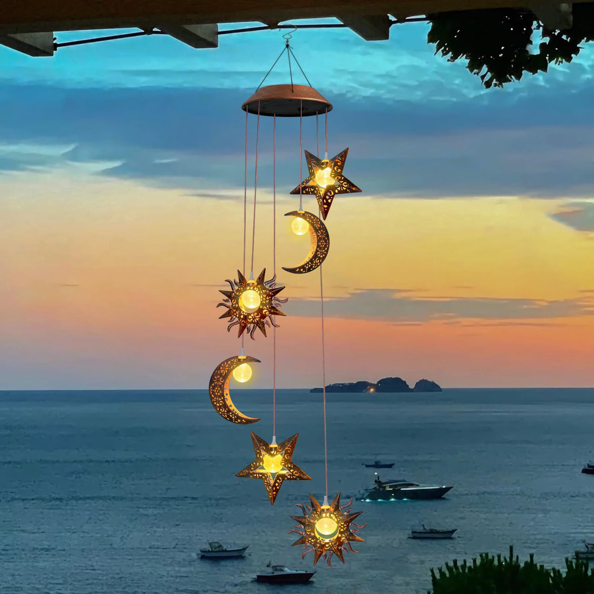 Beautyard solar wind chimes sun-moon-star glow enhances nighttime garden ambiance.