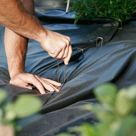 BEBEKULA artificial turf stake securing ground cover.