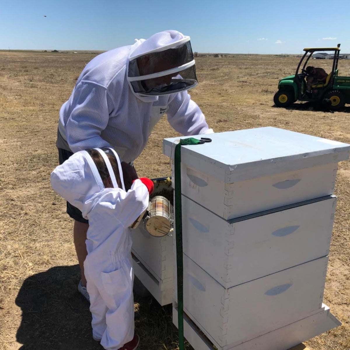 BEEXTM Kids Bee Suit worn in a backyard family beekeeping session.