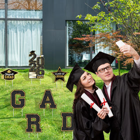 Biswiter graduation cap sign symbolizes achievement and marks the ceremony route.