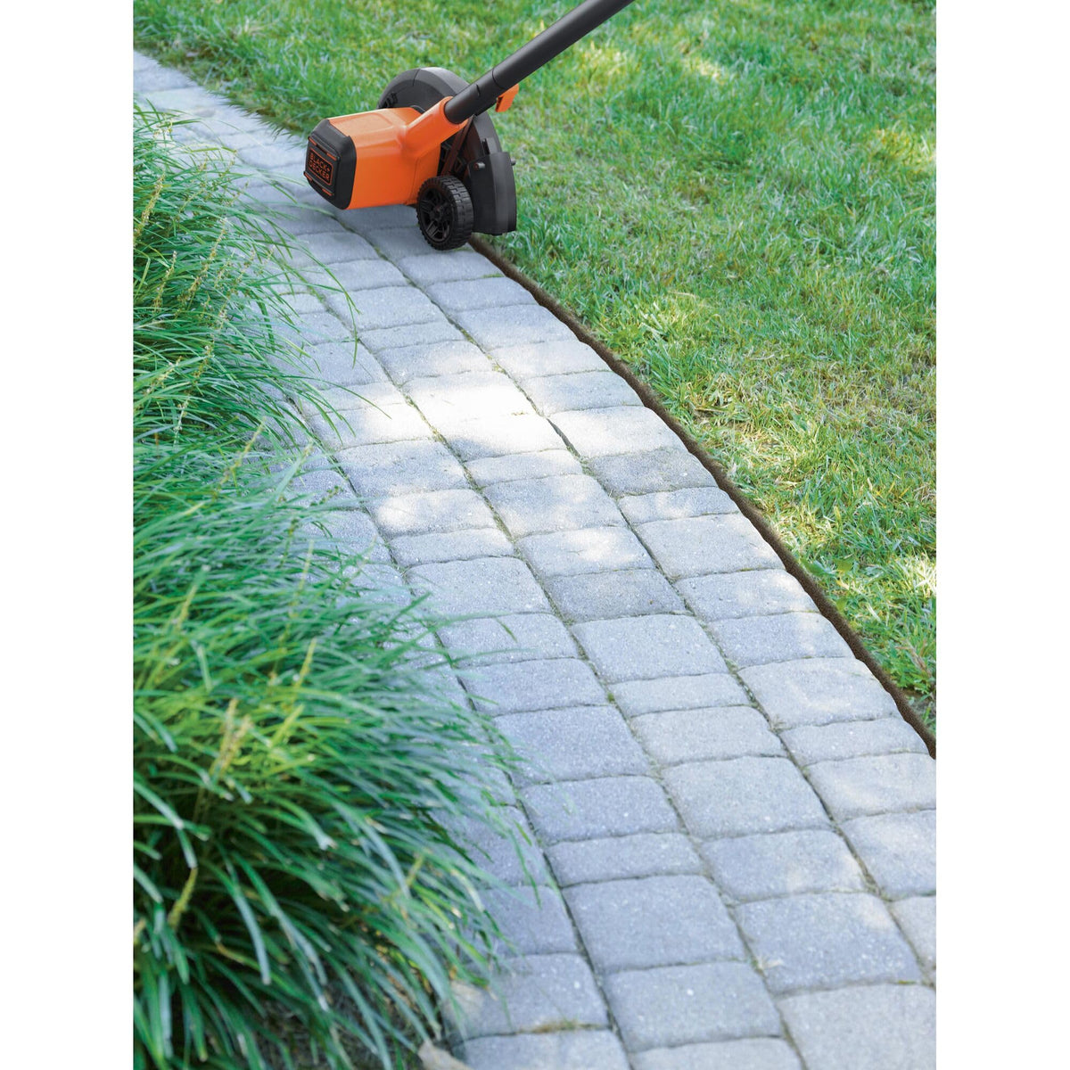 BLACK+DECKER 20V MAX edger in action for cordless lawn edging.