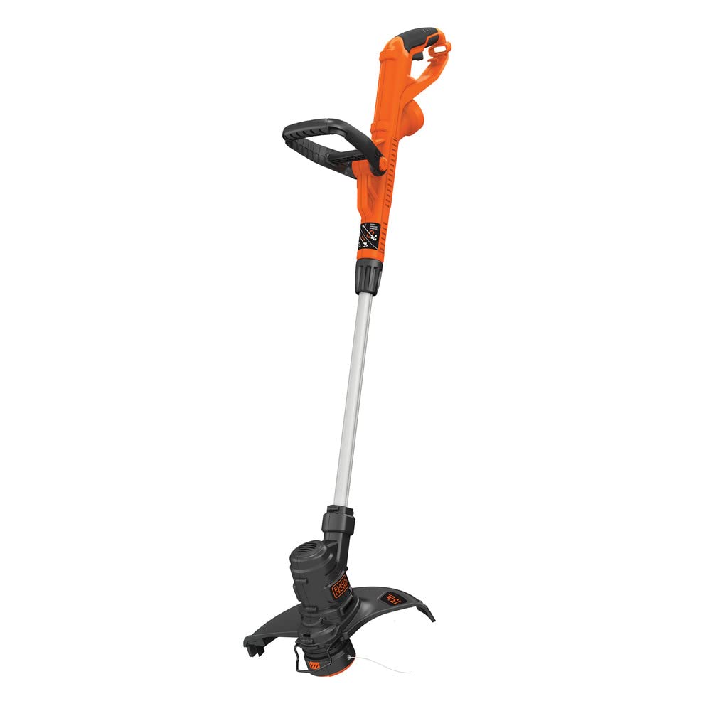 BLACK+DECKER ST8600 trimmer in action, edging along the sidewalk for a crisp boundary.