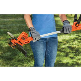  BLACK+DECKER Weed Wacker in use along a driveway for yard maintenance