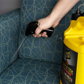 Spray action on ticks with Black Flag Extreme Flea Killer for direct contact control