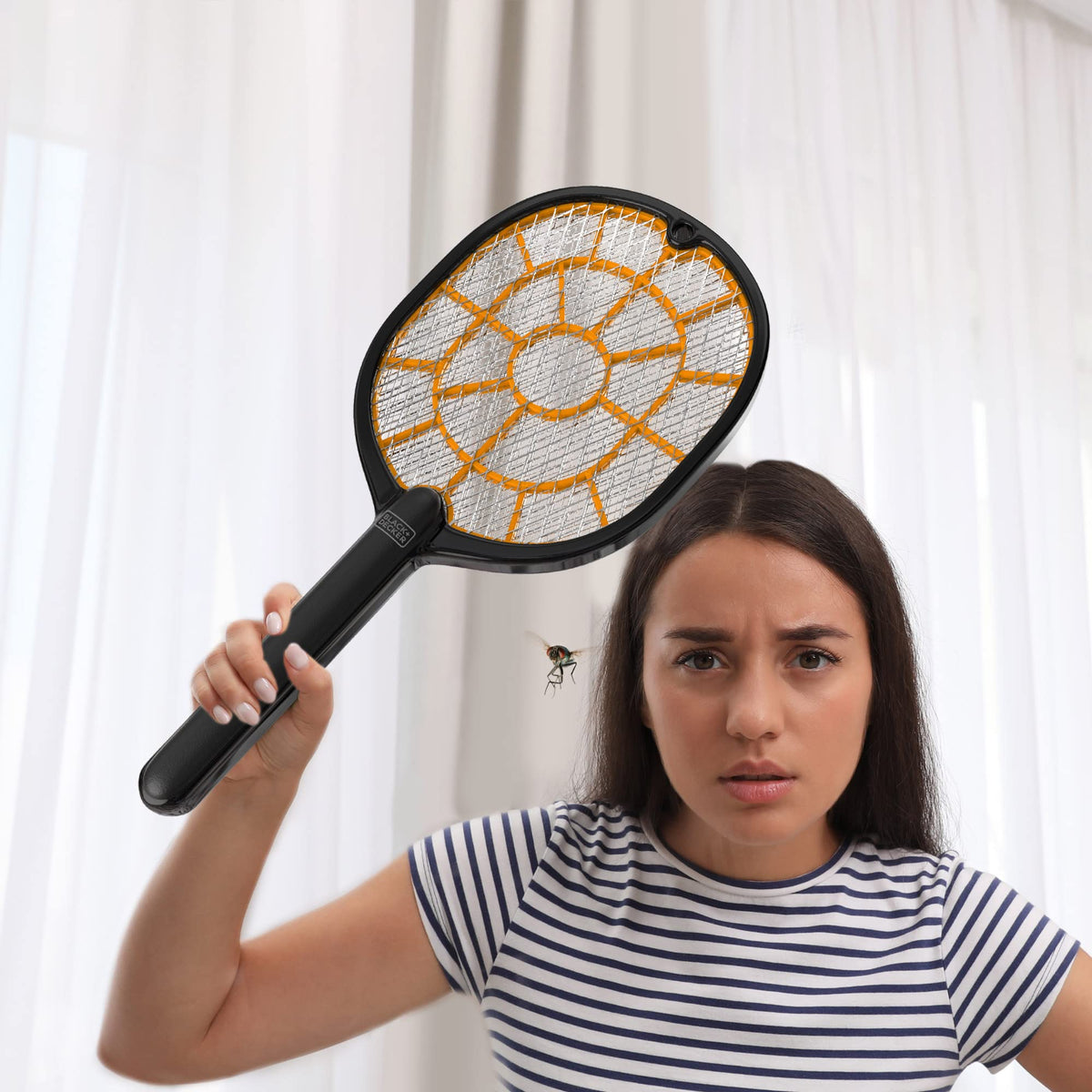 BLACK+DECKER Bug Zapper Racket in outdoor use on patio.