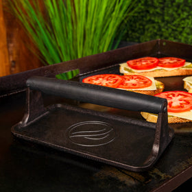 BLACKSTONE 5553 griddle press handle closeup shows heat resistant grip for safe cooking