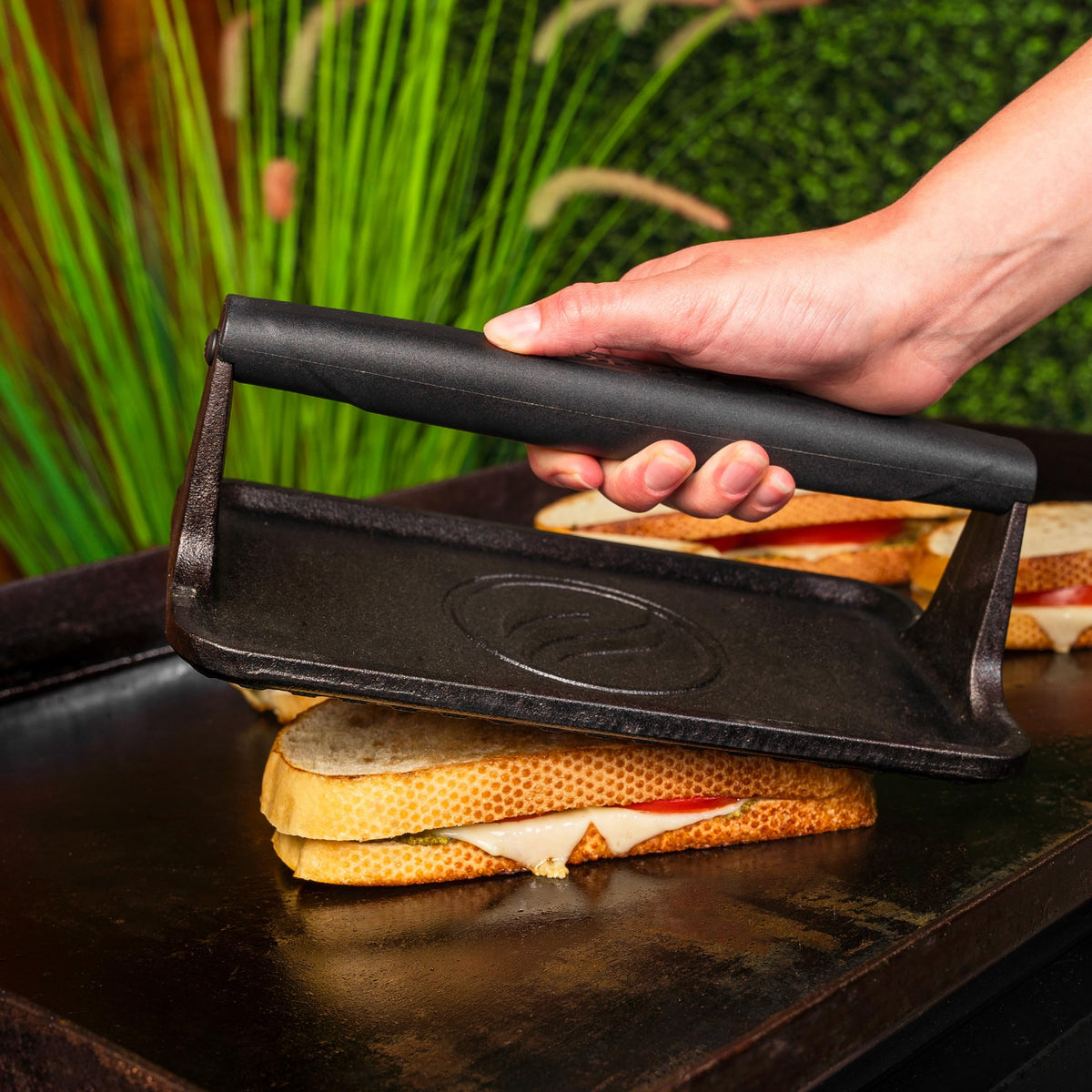 BLACKSTONE 5553 griddle press on grill showcases versatile outdoor use