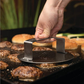 Close-up of Blackstone burger press in stainless steel highlighting durable construction.