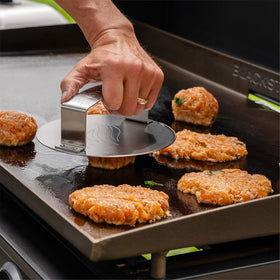 Blackstone Smash & Sear Press ergonomic handle enabling steady patty smashing.