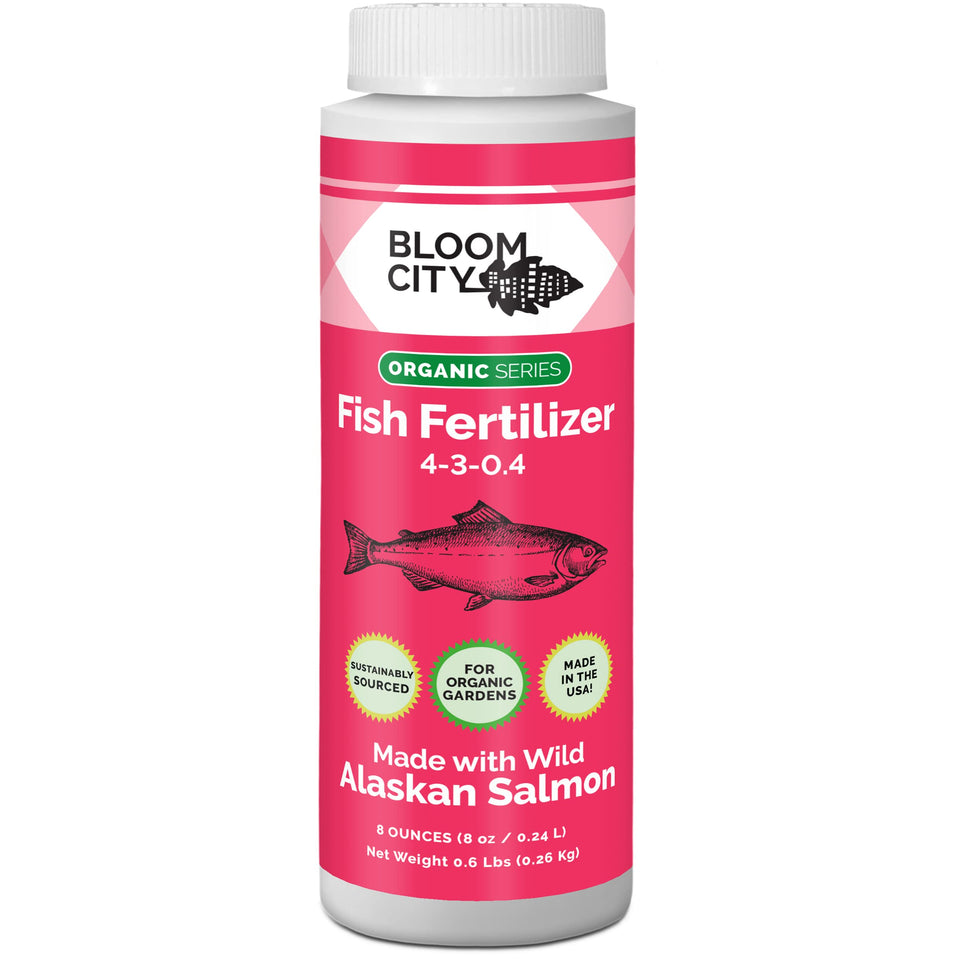 Bloom City Wild Fish Fertilizer bottle pour supports lush green leaves