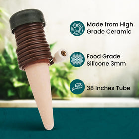Indoor plant setup with Blumat stakes enabling hands-free hydration.