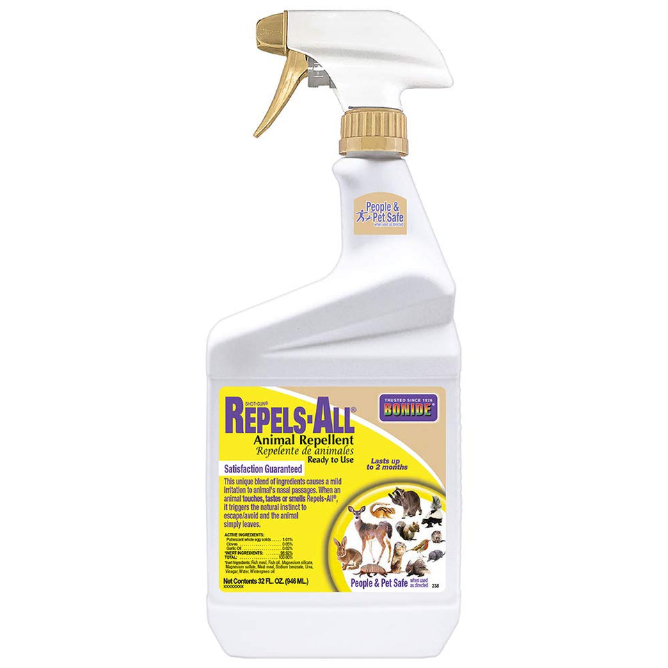 Bonide Repels-All spray bottle applying to garden foliage to deter deer and rabbits