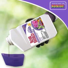 Bonide Rose Shield Drench being poured around a rose bed for easy application