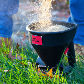 Brinly 5lb spreader all-season design handles ice melt and fertilizer.