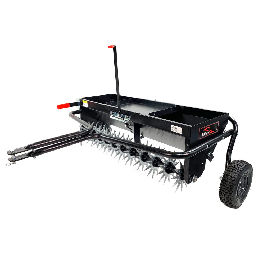 Brinly tow behind aerator-spreader assembly for efficient lawn care and even material distribution.