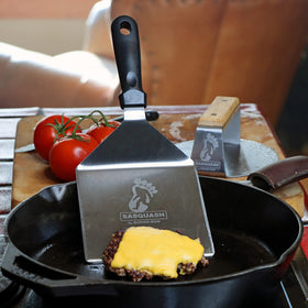 Burger Iron Sasquash spatula ergonomic handle for secure grip during busy flips.