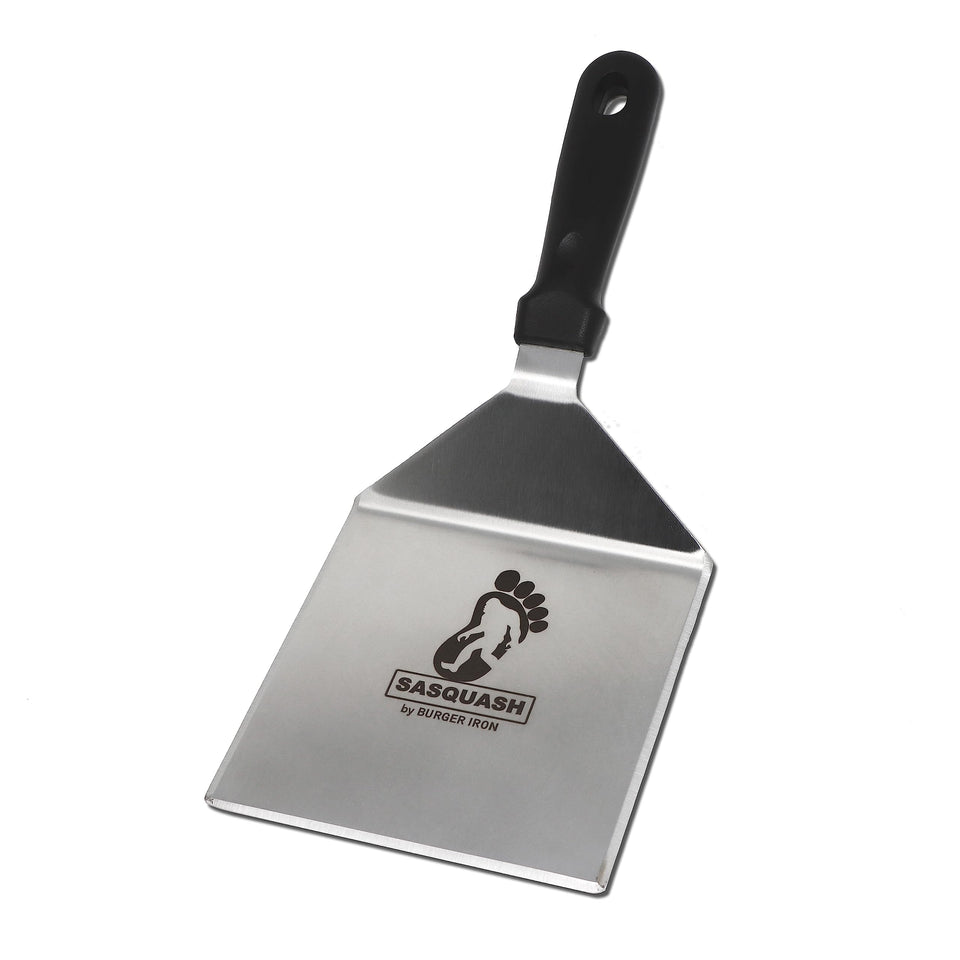 Burger Iron Sasquash spatula with wide face for steady flips on burgers and pancakes.